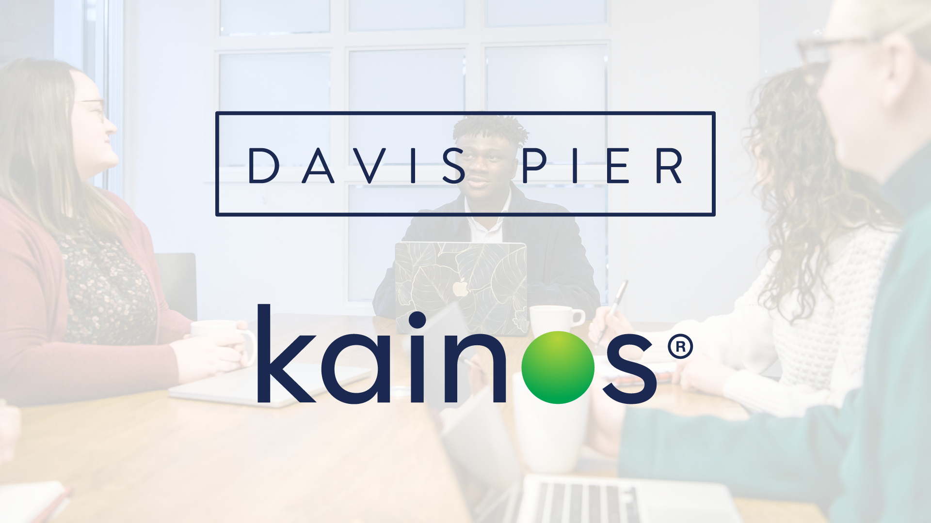 Davis Pier and Kainos logos over a faded photo of the Davis Pier team meeting in one of our conference rooms.