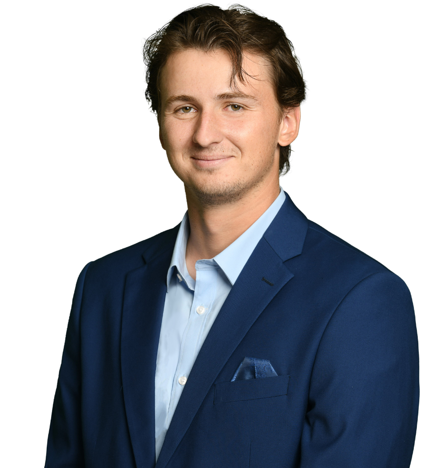 Image of a man in a navy blazer with dark hair.