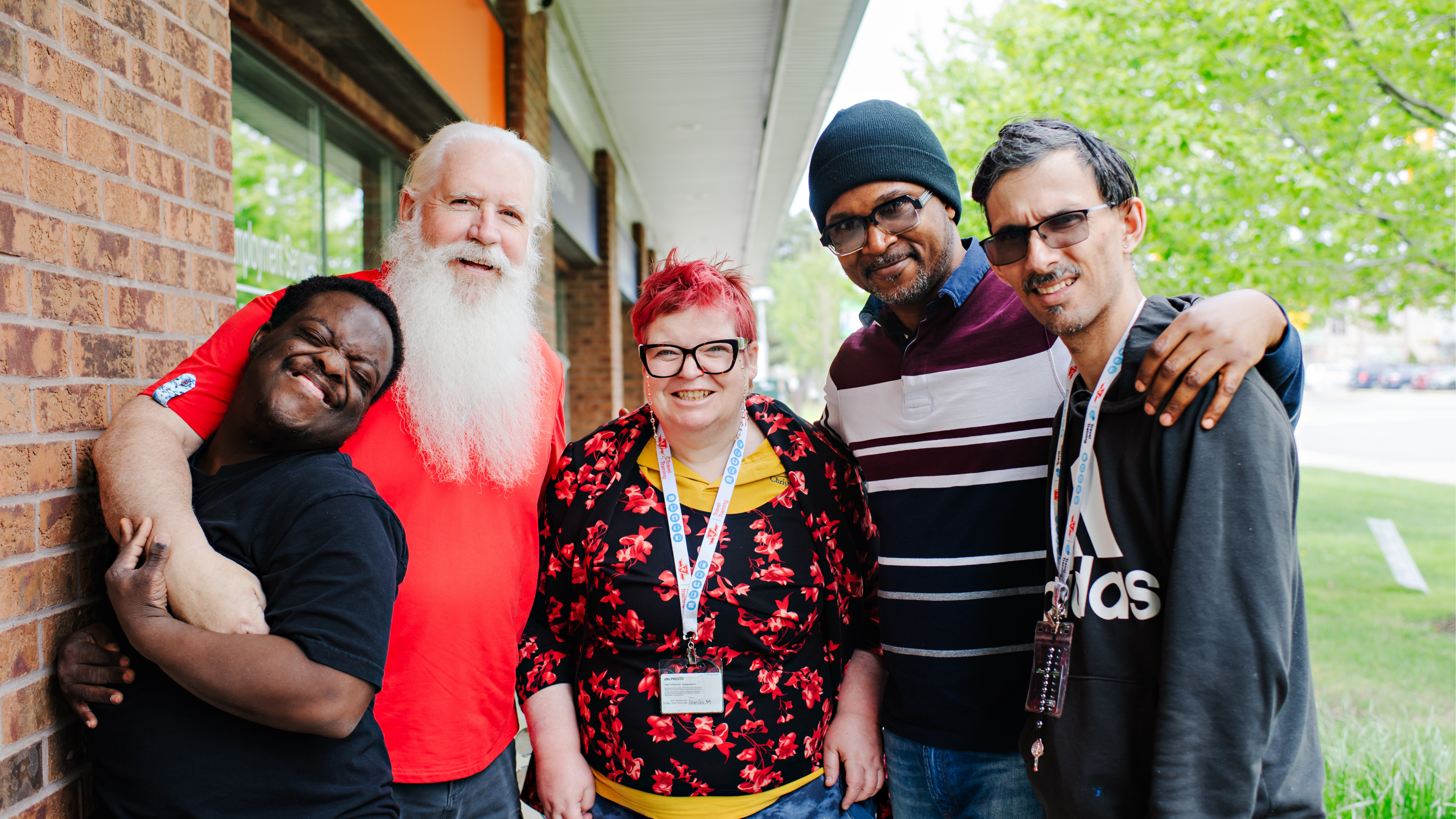 A group of people standing together and smiling at the camera