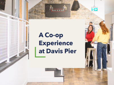 Graphic that reads "A Co-op Experience at Davis Pier" over a photo of people talking in the kitchen of the Davis Pier office.