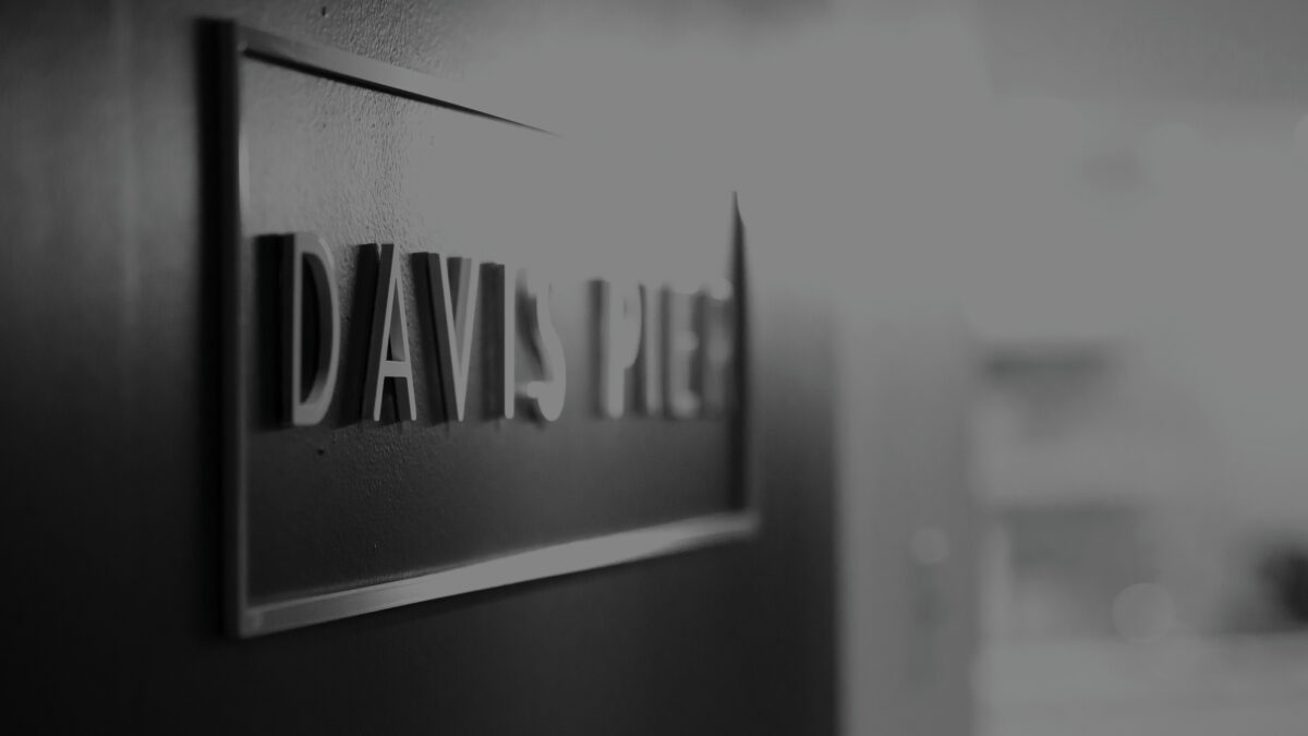 A photo of a Davis Pier logo in the form of pin-mounted signage