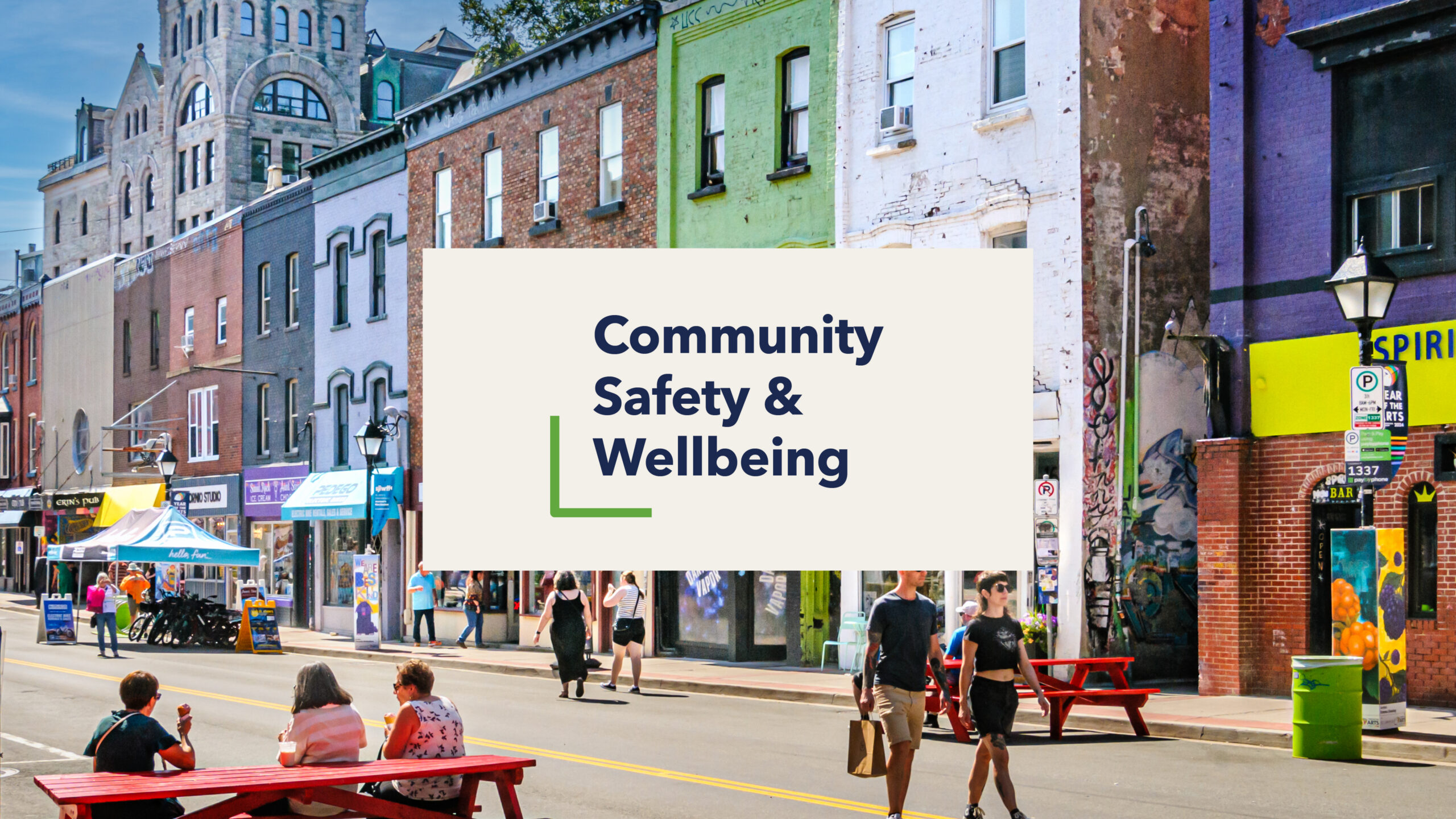 Colourful downtown streetscape in Atlantic Canada. The photo features local businesses, pedestrians, and historic buildings in an urban main street setting.